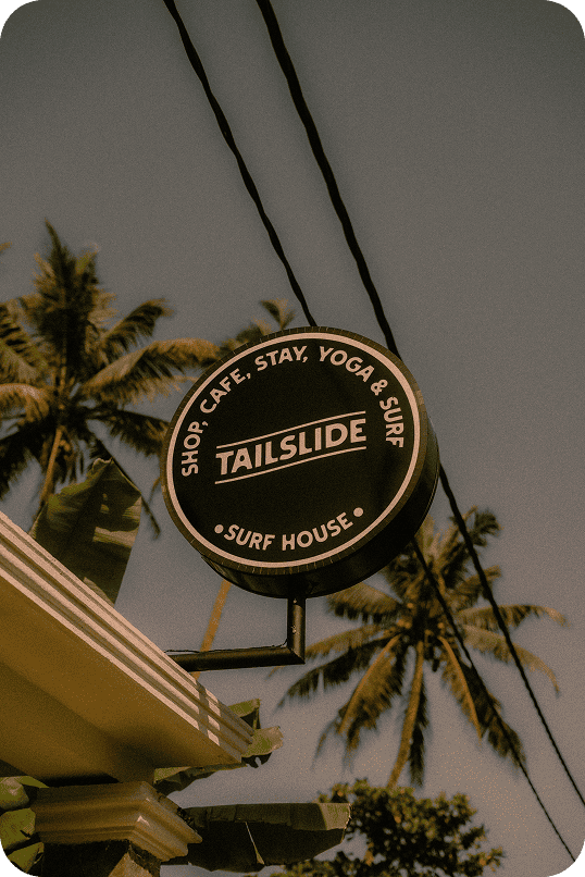 Tailslide surf house signboard with palm trees_local surf coaching madiha_local surf knowledge_about