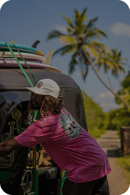 Tailslide_local surf coach loading boards onto tuk tuk_Madiha local surfer Sri Lanka from professional surfer to professional surf coach_About