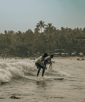 Tailslide local surf lessons_student surfing small wave with local surf coach_learn to surf after 30_professional and technical surf coaching Sri Lanka_About