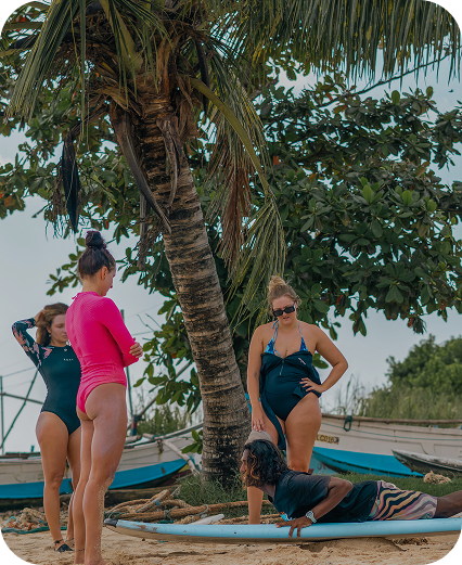 Tailslide technica surf coaching lessons sri lanka_total beginner girl surf students learning with professional coach on Madiha beach_total beginner surf lessons Sri Lanka_Coaching