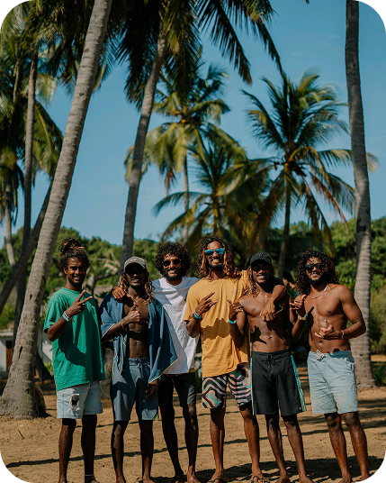 Tailslide technical surf coaching lessons Sri Lanka_group of local surf coaches standing under palm trees at Coconut tree hill Mirissa_local coaches with proffessional surf skills and perfect english level_Coaching
