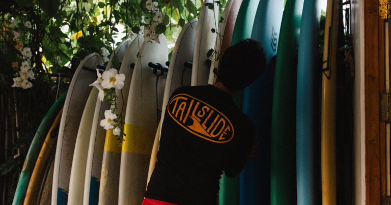 Surfer looking at all sizes surf boards